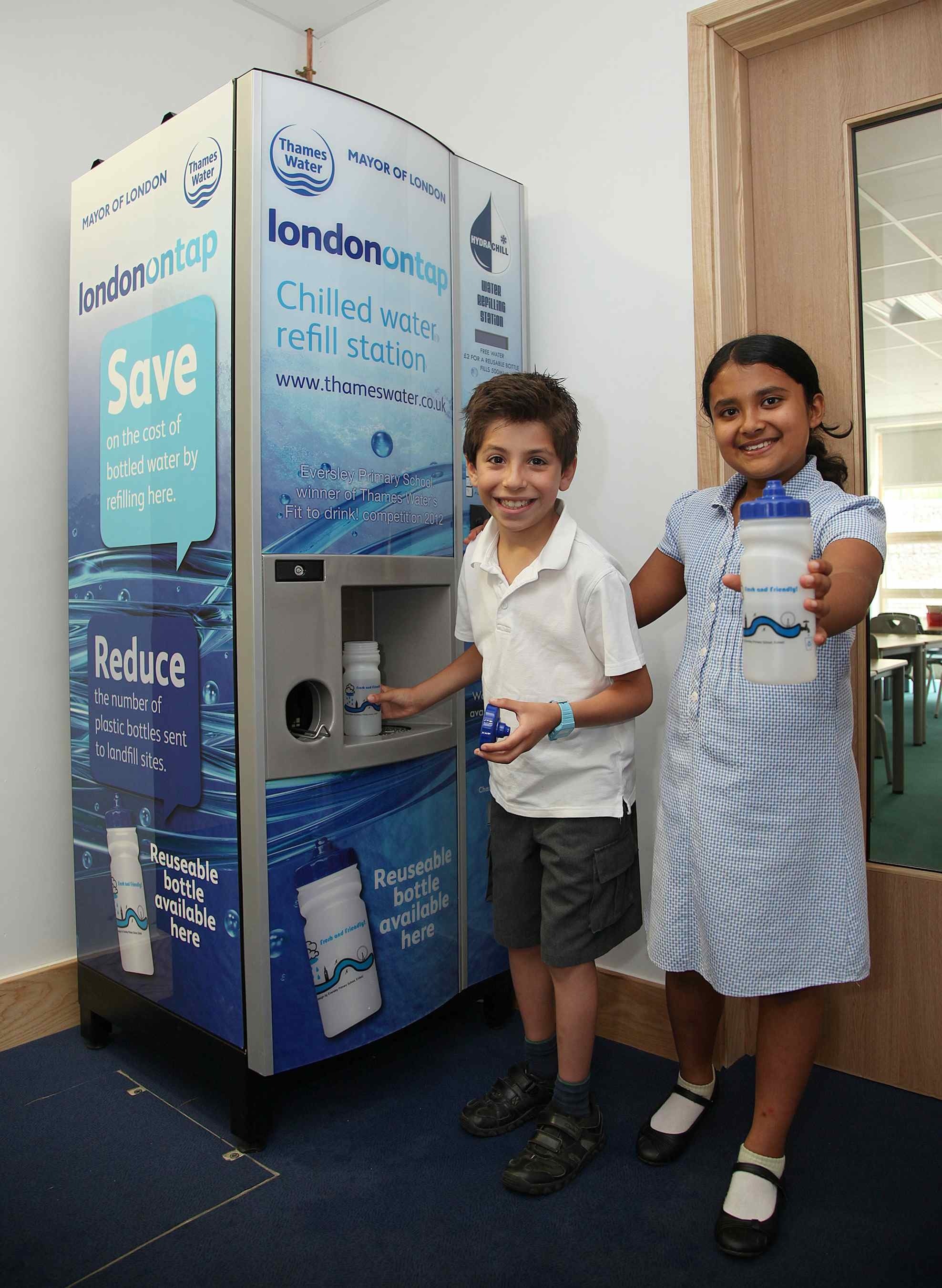 Children next to water machine